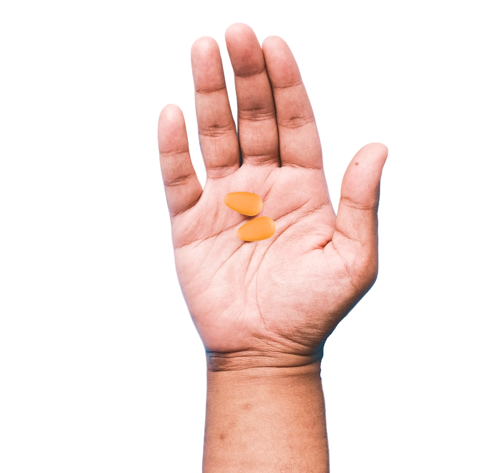 palm holding two tadalafil pills