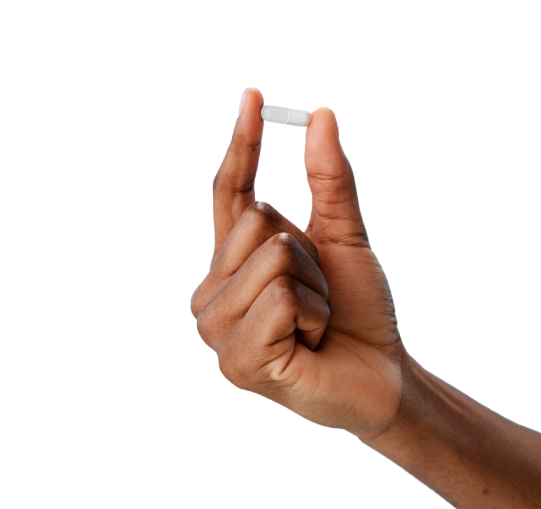 Fingers holding blue pill